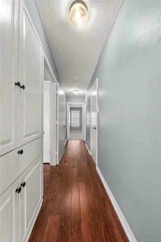 a view of hallway with wooden floor