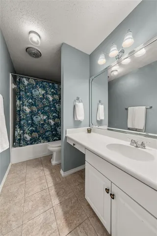 a bathroom with a sink a large mirror and a bathtub