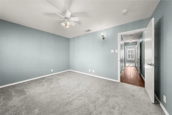 an empty room with closet and windows