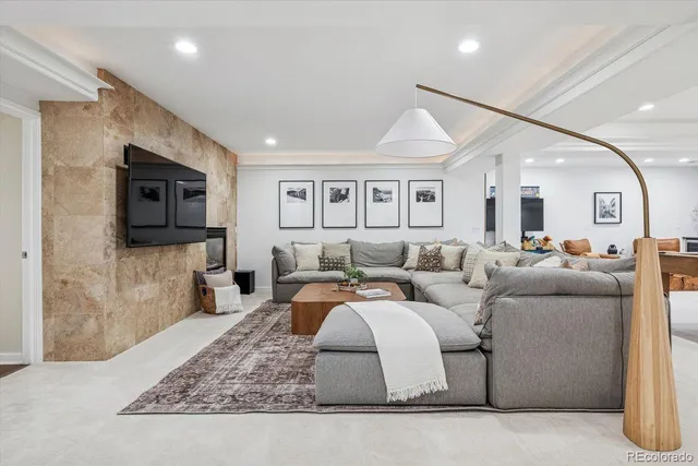 a living room with furniture flat screen tv and a fireplace
