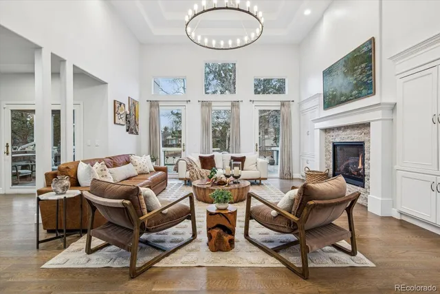 a living room with furniture a fireplace and a large mirror