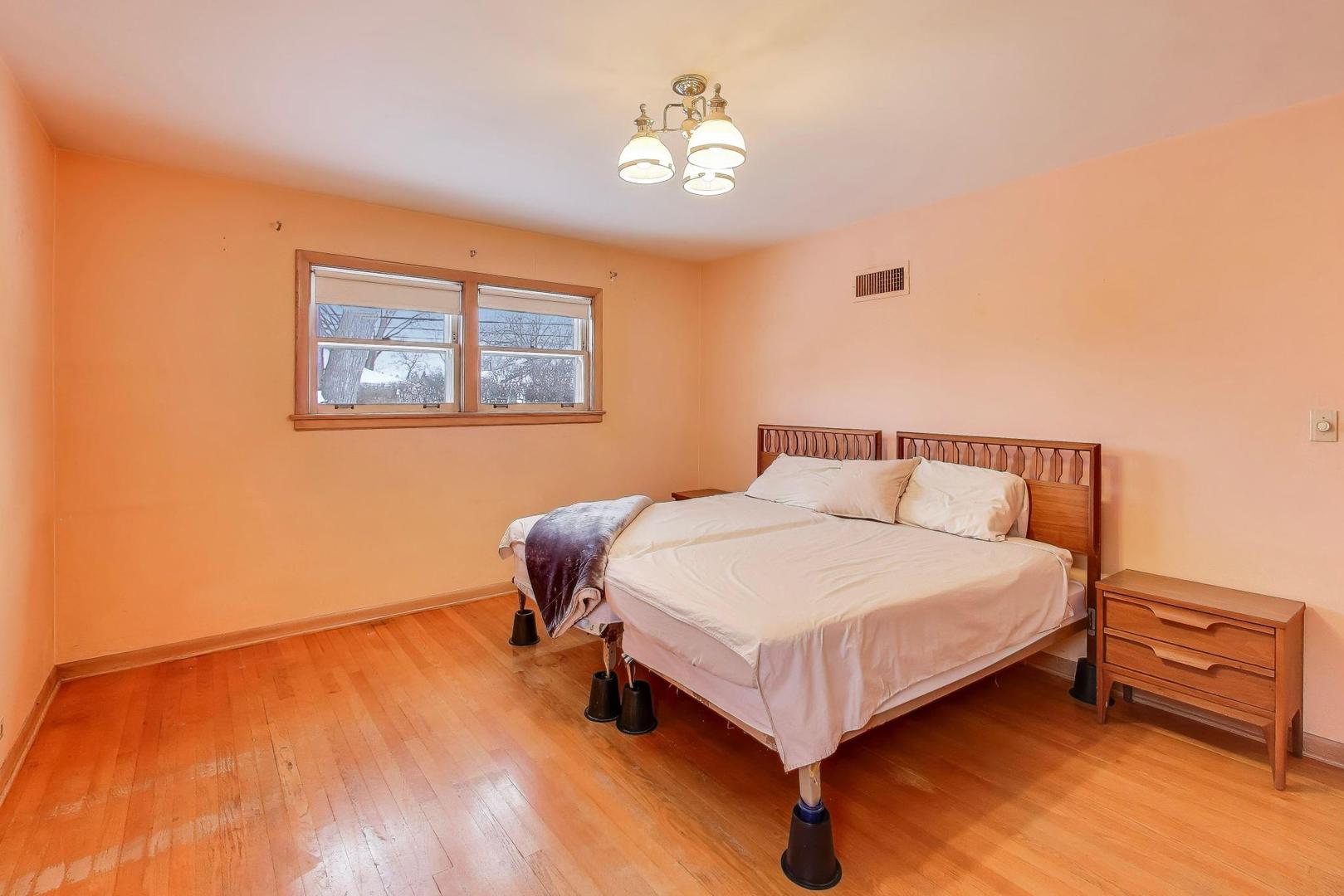 820 North Delphia Avenue Park Ridge, IL 60068 - Photo 12 of 24 a bedroom with a bed and a night stand