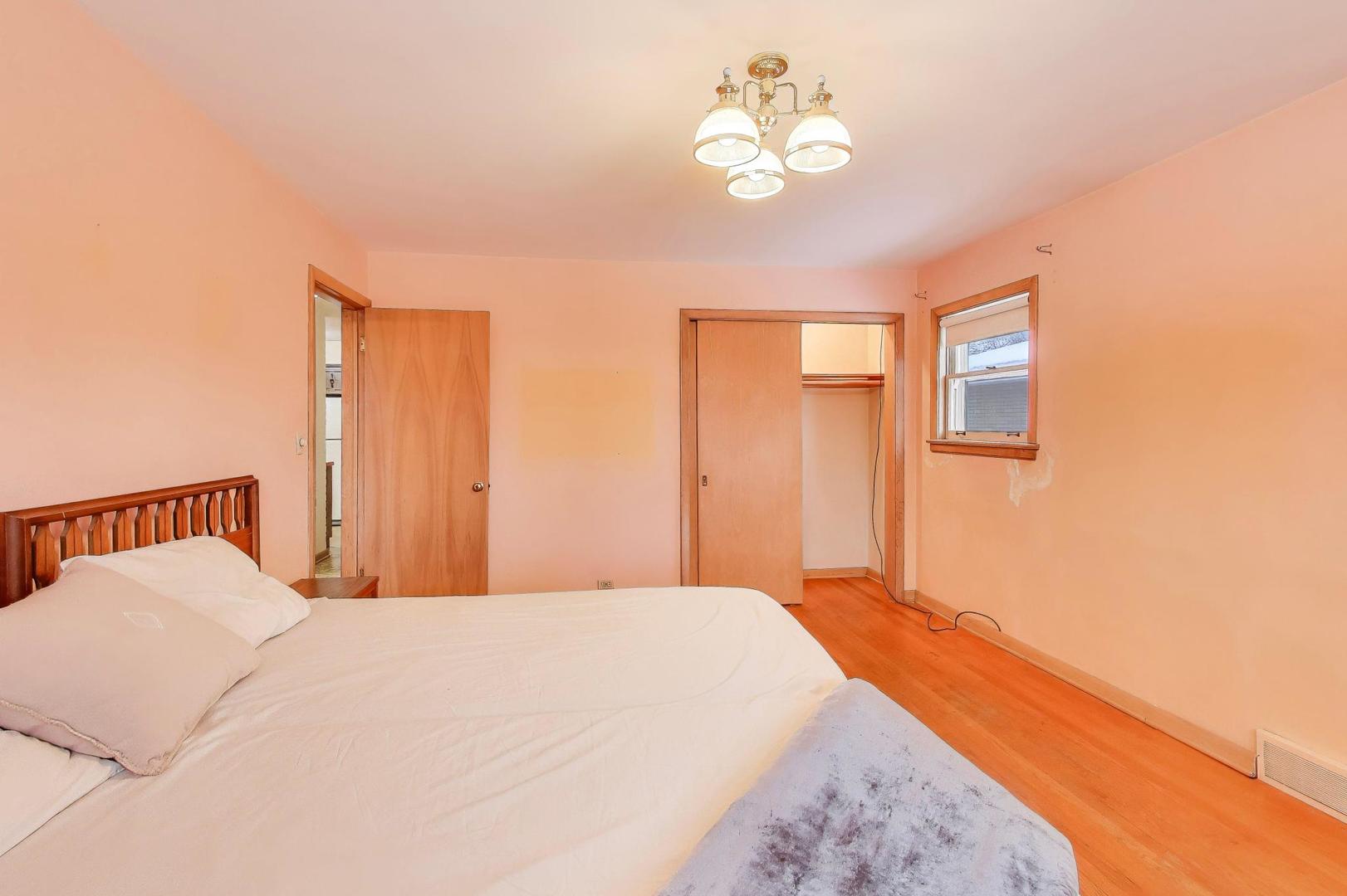 820 North Delphia Avenue Park Ridge, IL 60068 - Photo 13 of 24 a bedroom with a bed and a chandelier