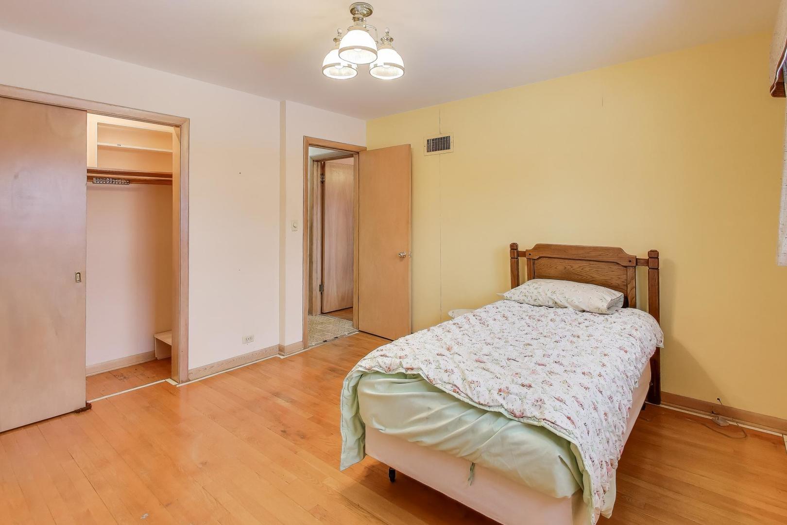 820 North Delphia Avenue Park Ridge, IL 60068 - Photo 15 of 24 a bedroom with a bed and a chandelier