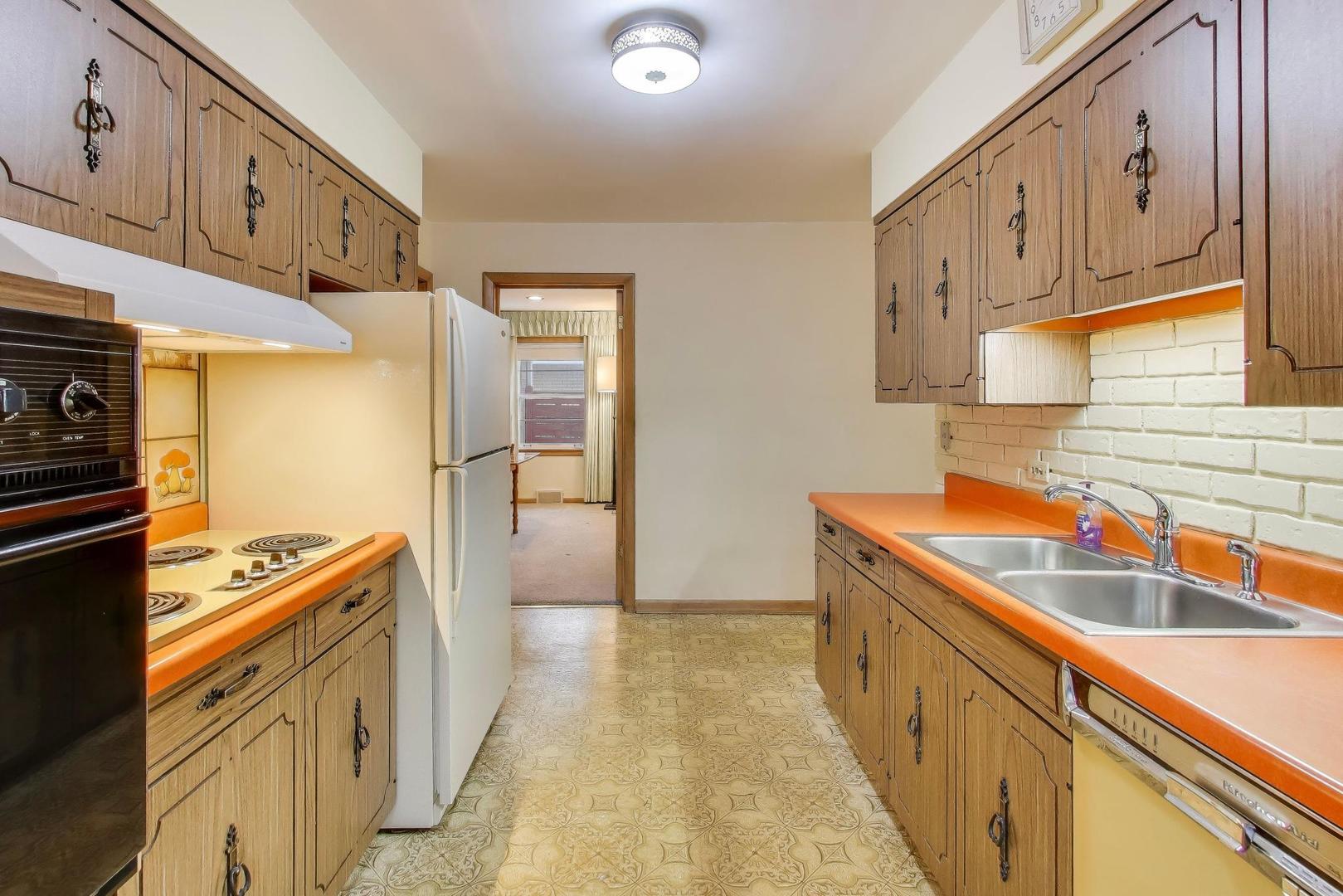 820 North Delphia Avenue Park Ridge, IL 60068 - Photo 9 of 24 a kitchen with stainless steel appliances granite countertop a sink and a stove