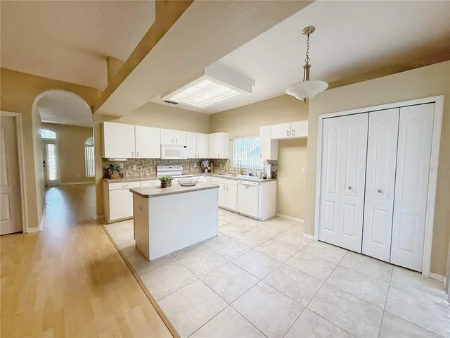 a large kitchen with cabinets and stainless steel appliances