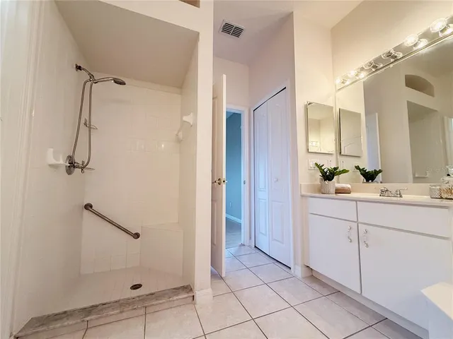 a bathroom with a shower sink and mirror