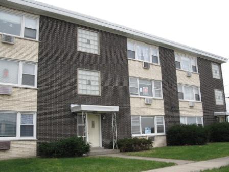 7531 Roberts Road, Unit 2B Bridgeview, IL 60455 - Photo 1 of 7 a front view of a brick house with a yard