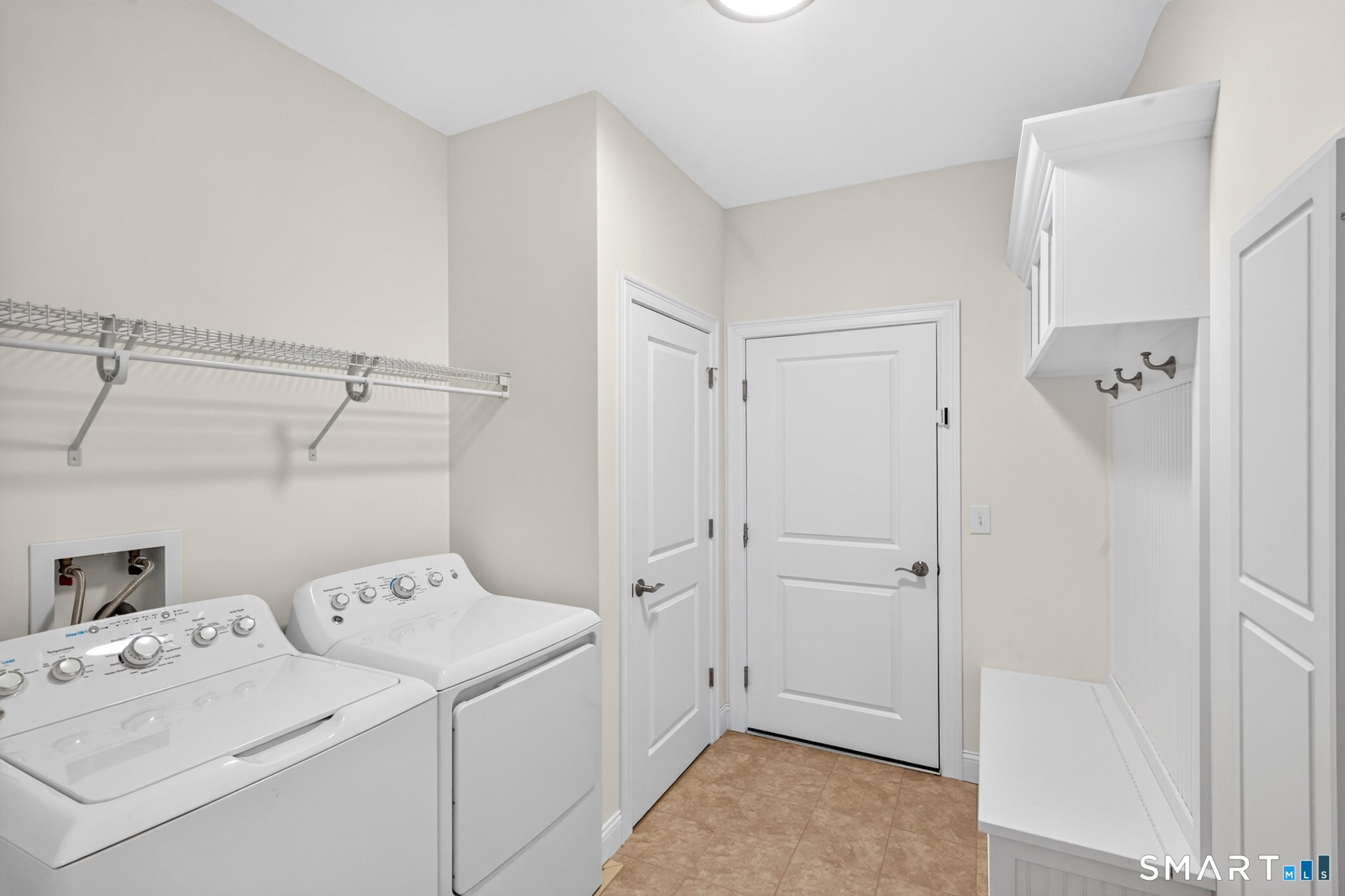 6 Prospect Ridge, Unit 6 Simsbury, CT 06070 - Photo 32 of 33 The laundry/mud room has great storage with a built-in storage bench that opens up for additional storage