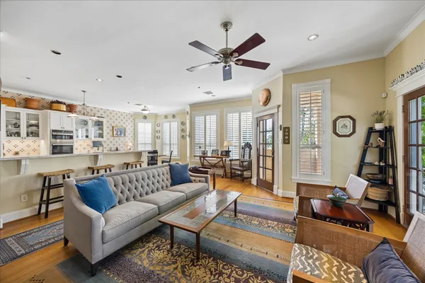 a spacious bedroom with a bed a couch and large window