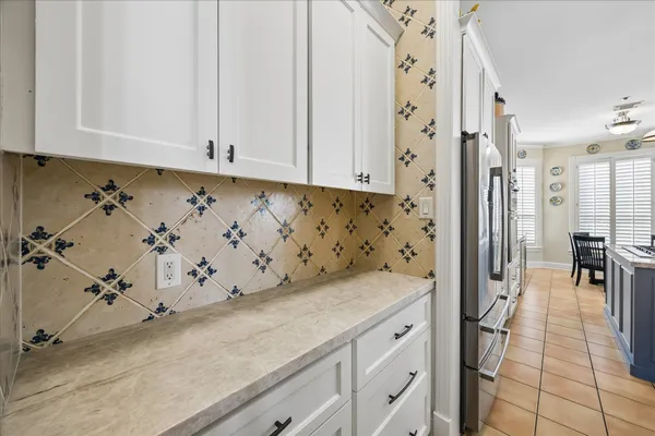 a large white kitchen with a large window