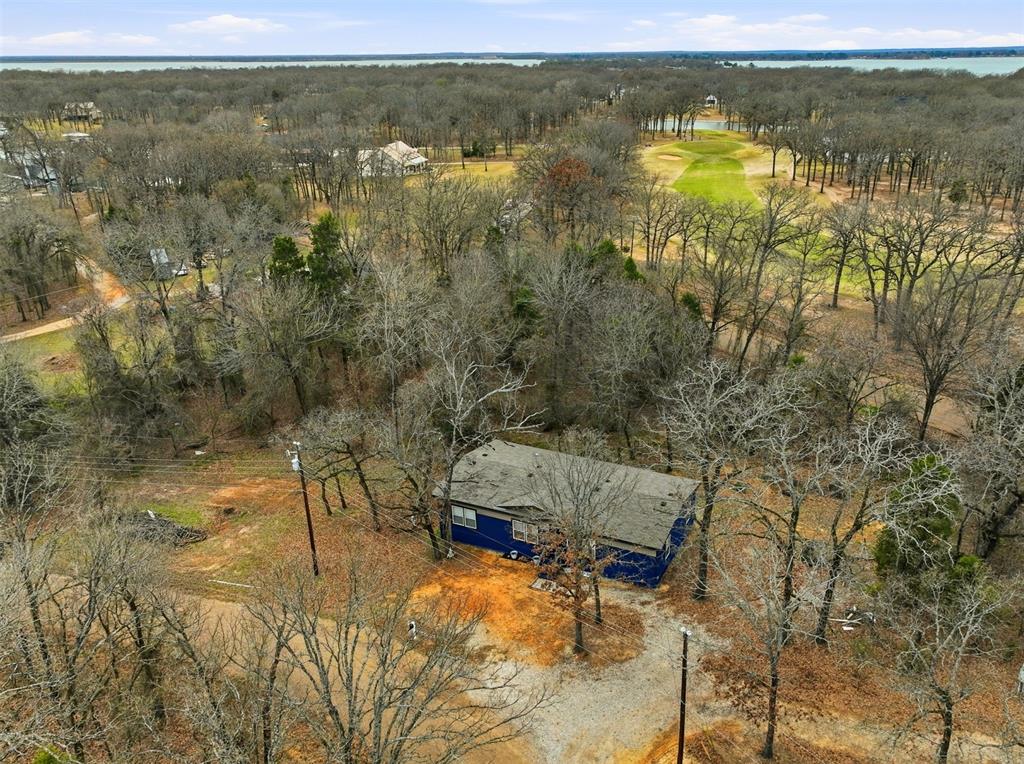 2114 Hickory Street Mabank, TX 75156 - Photo 4 of 31 View of home with golf course behind the home and nearby Cedar Creek Lake in the background.