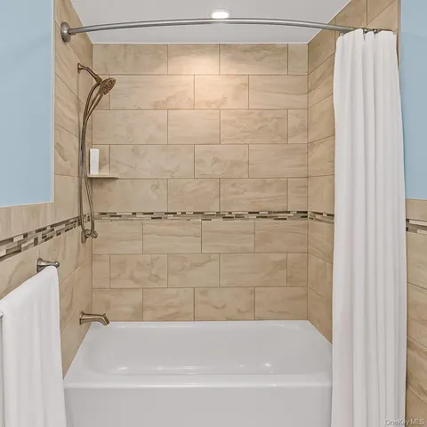 a bathroom with a shower and a bath tub