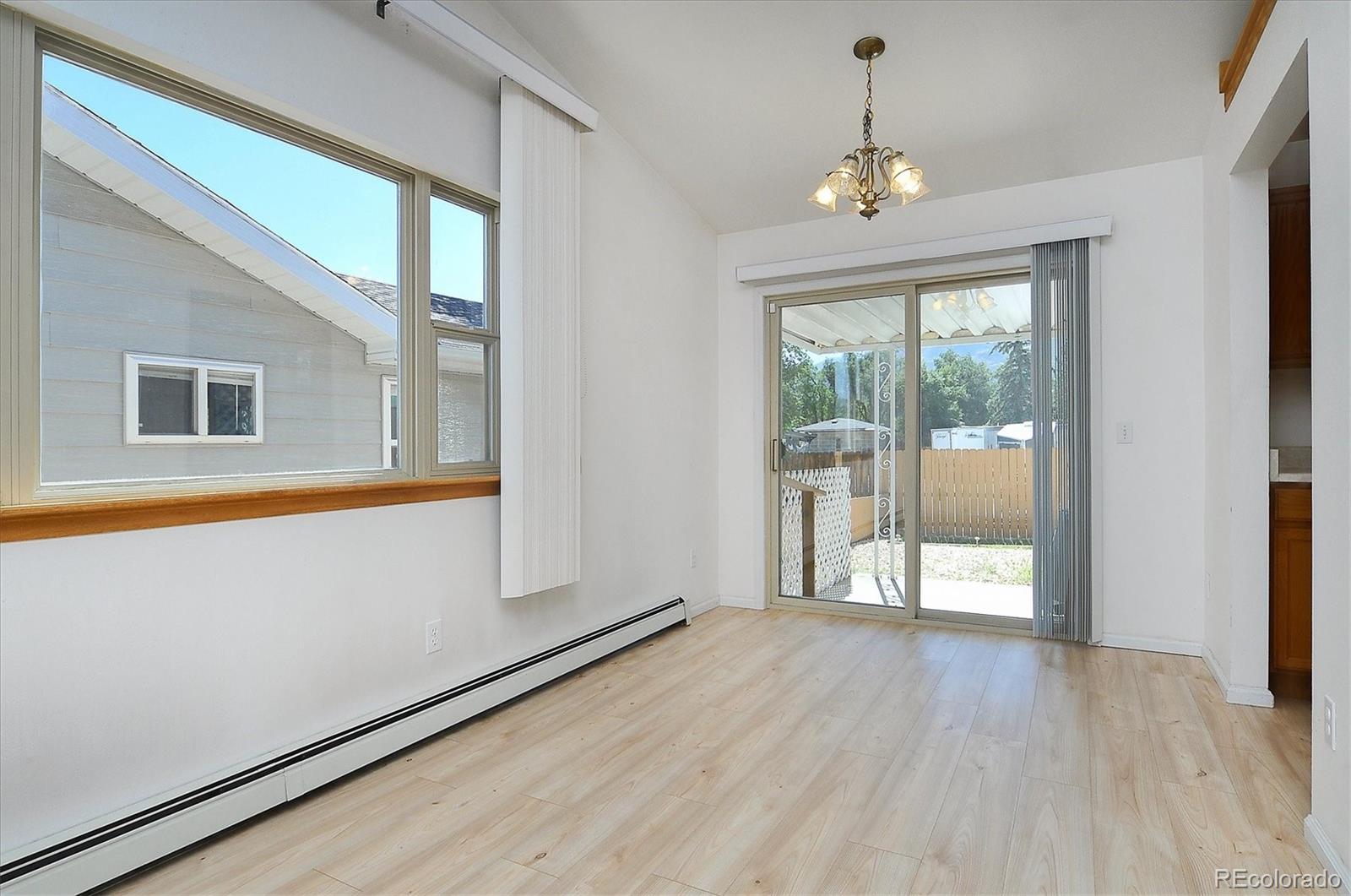 29 Rex Circle Salida, CO 81201 - Photo 13 of 31 a view of an empty room with wooden floor and a window