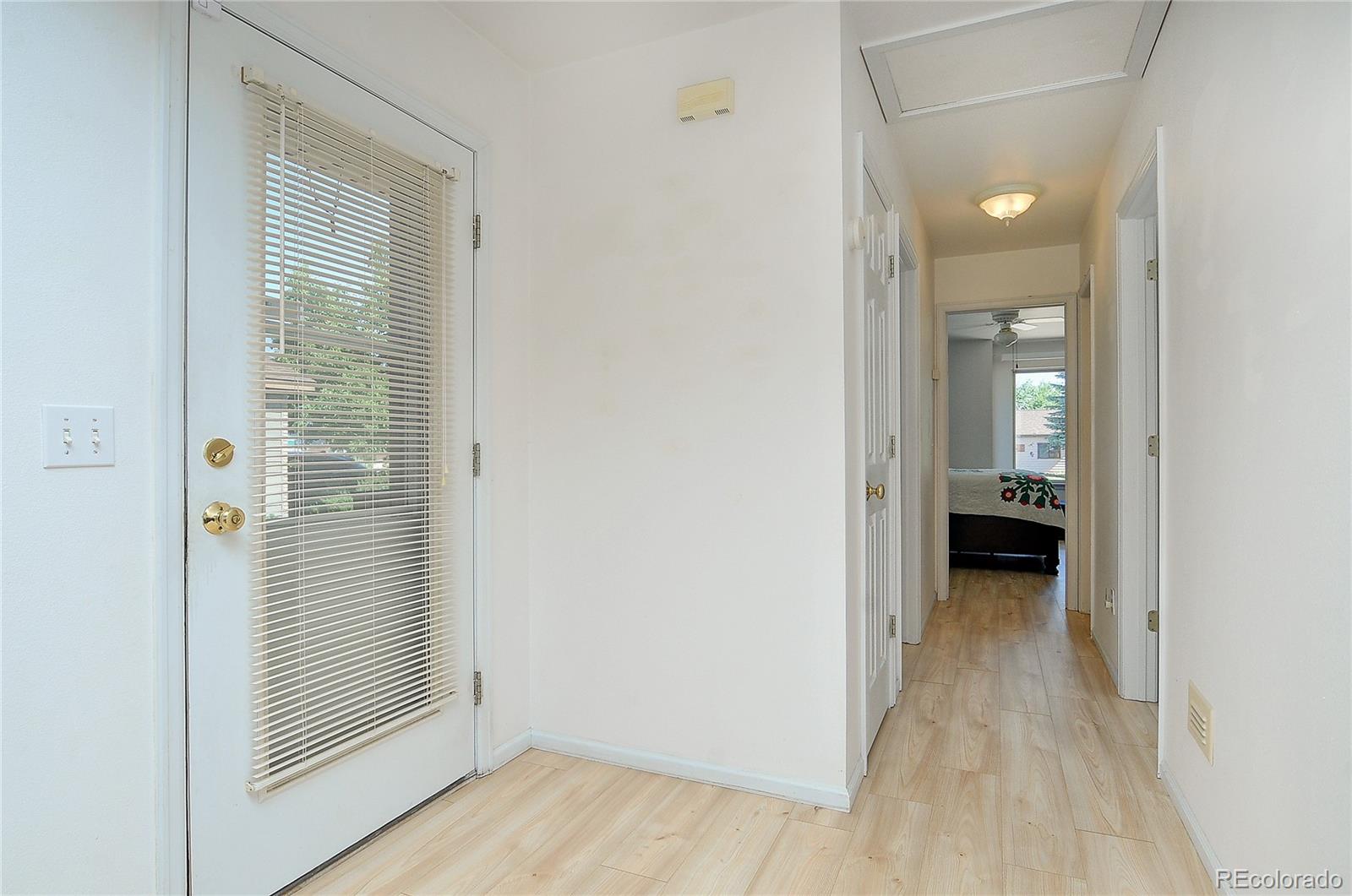 29 Rex Circle Salida, CO 81201 - Photo 14 of 31 a view of a hallway with wooden floor and a bathroom