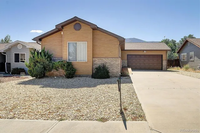 a front view of a house with yard
