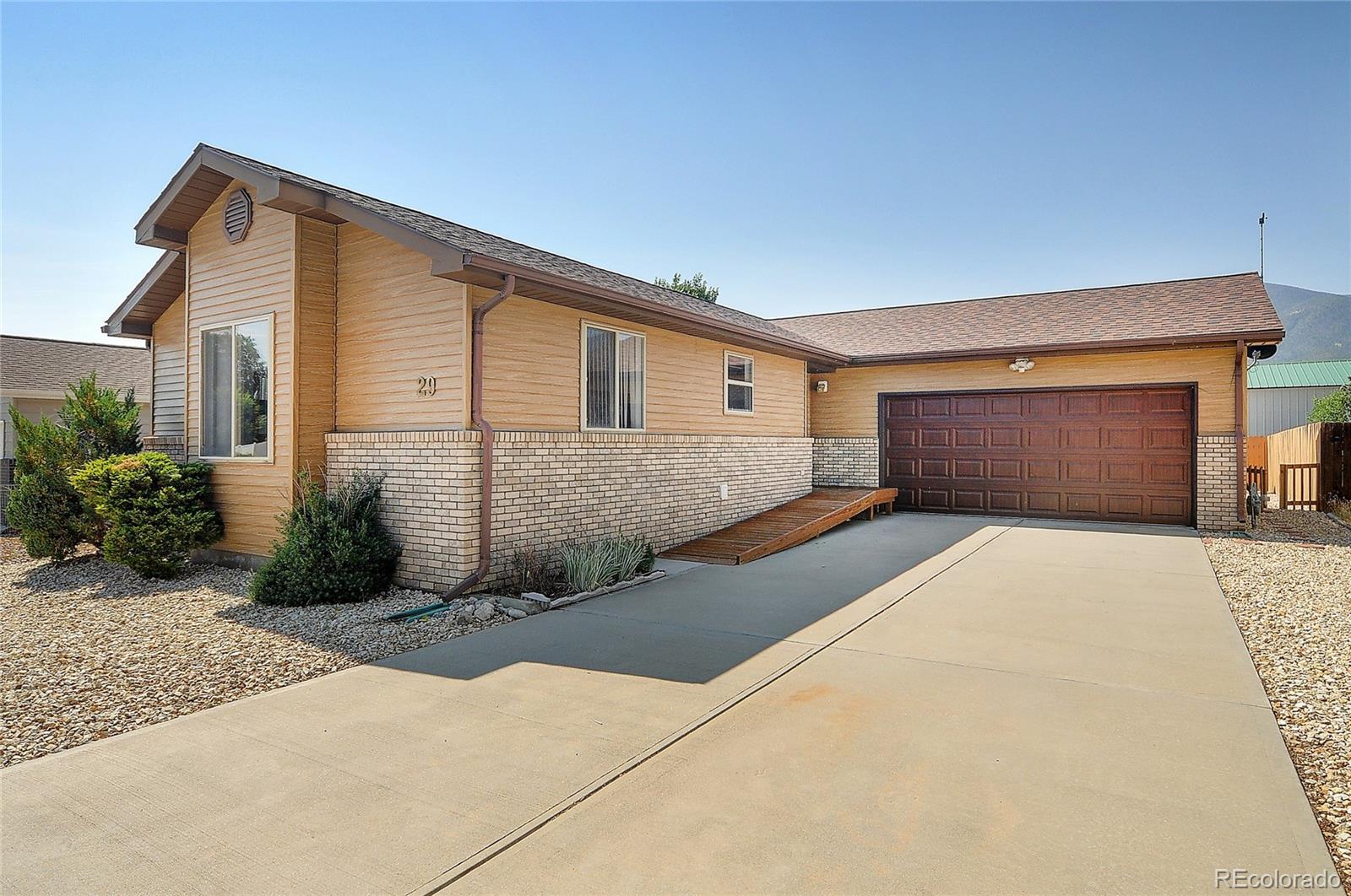 29 Rex Circle Salida, CO 81201 - Photo 24 of 31 a front view of a house with a yard and garage