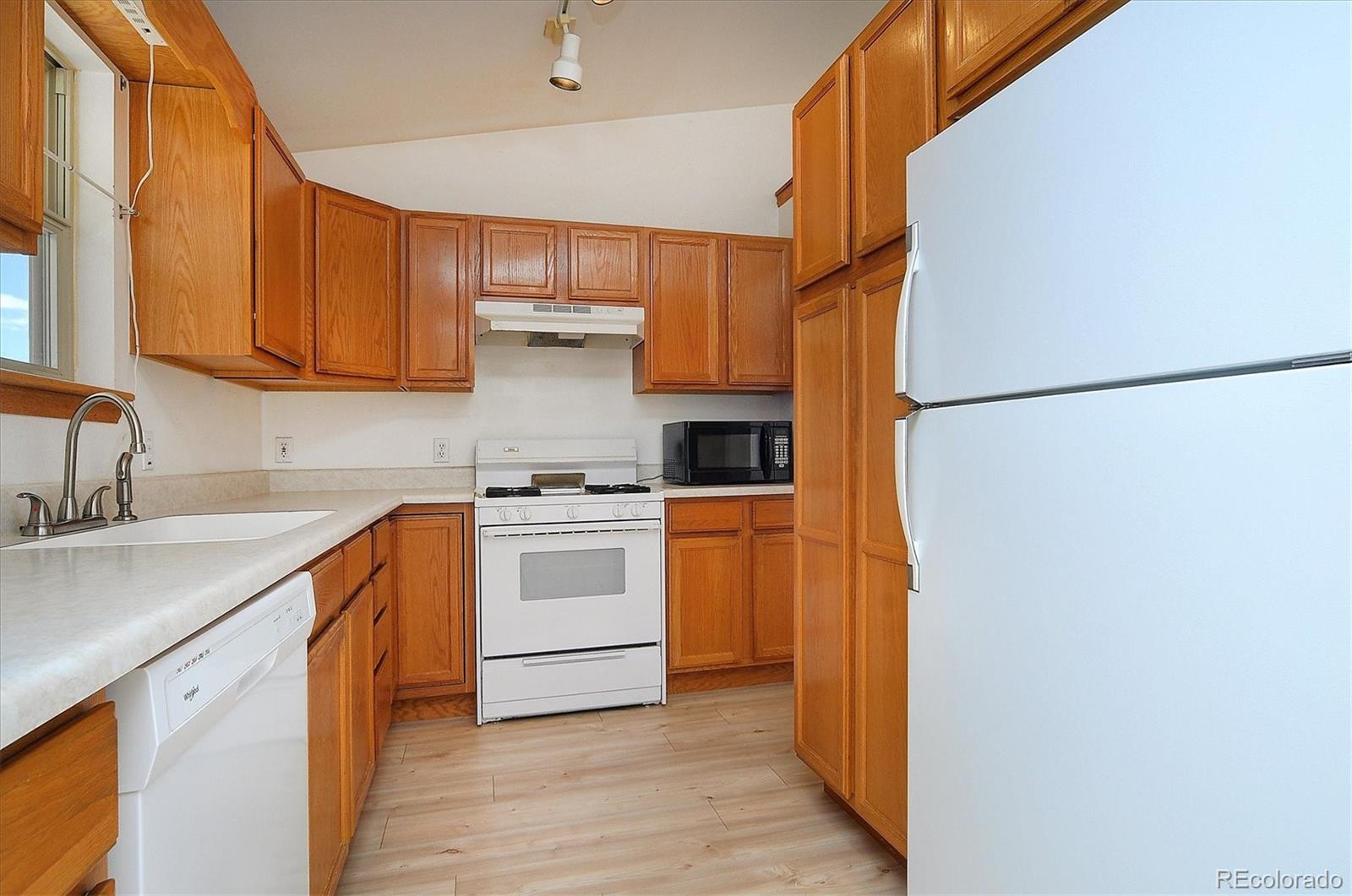 29 Rex Circle Salida, CO 81201 - Photo 9 of 31 a kitchen with a white stove refrigerator and cabinets