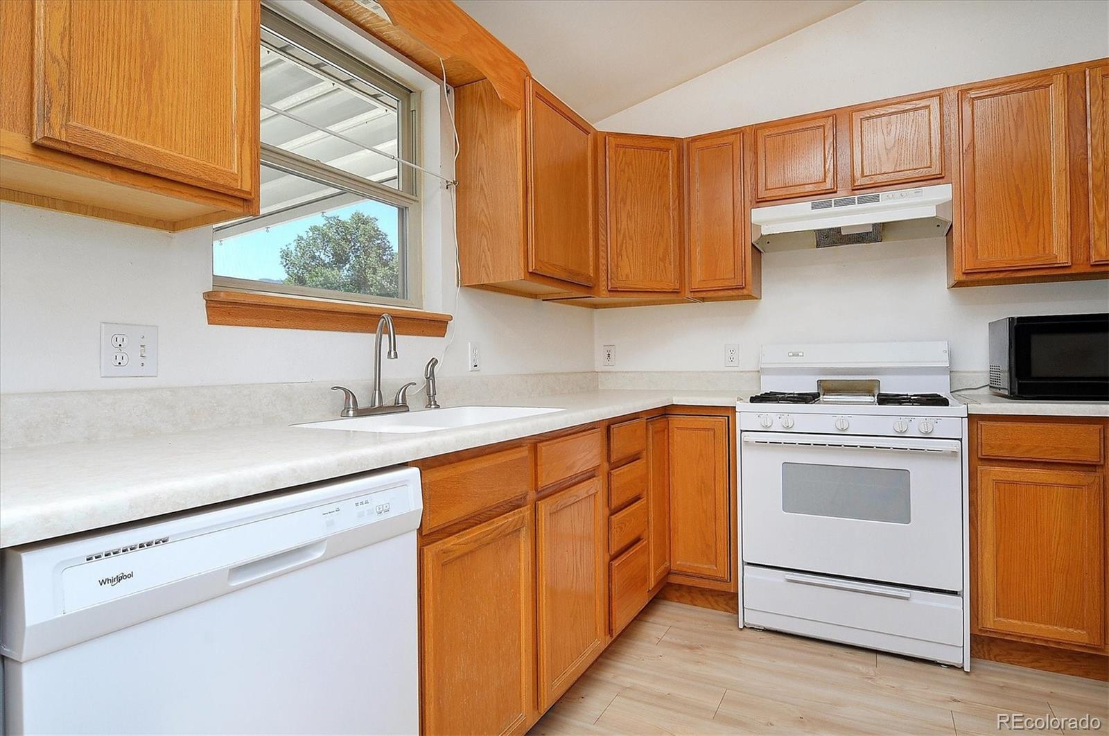 29 Rex Circle Salida, CO 81201 - Photo 10 of 31 a kitchen with stainless steel appliances granite countertop a sink a stove and a refrigerator