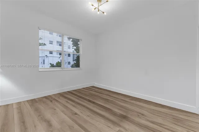 a view of room with window and hardwood floor
