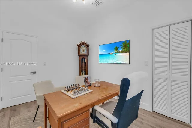 a view of a dining room with furniture and wooden floor