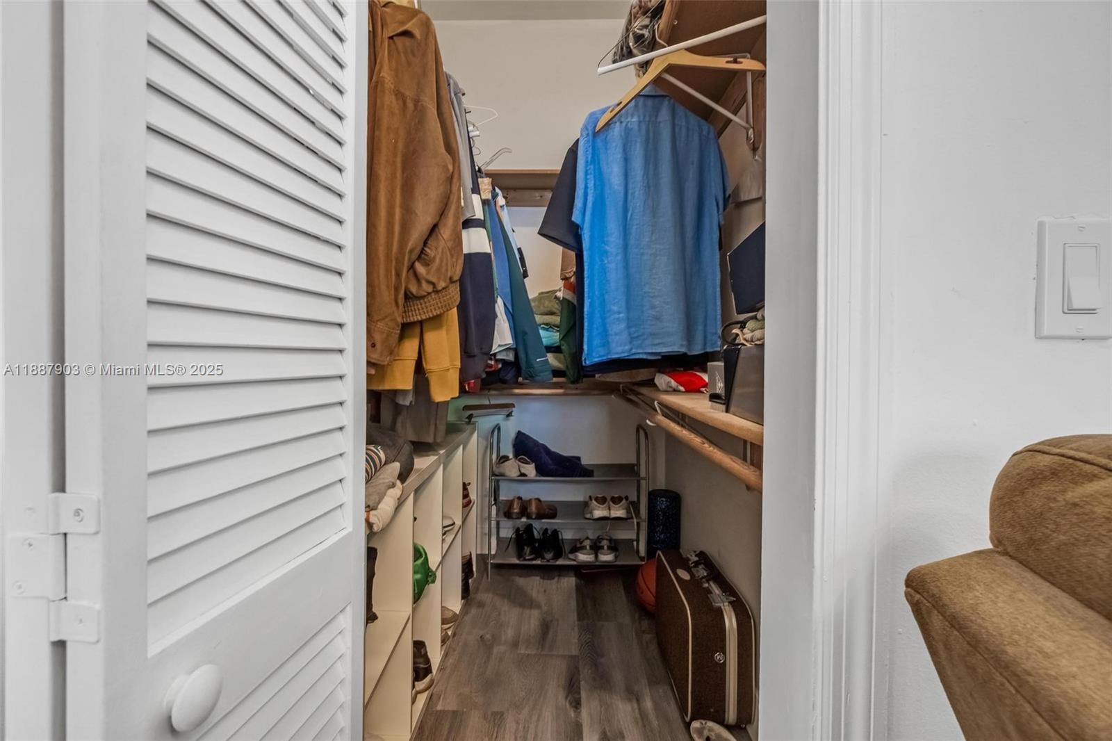 3067 Center Street, Unit 17 Miami, FL 33133 - Photo 13 of 21 a view of walk in closet with clothes and shoes