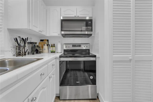 a kitchen with granite countertop a stove and a sink