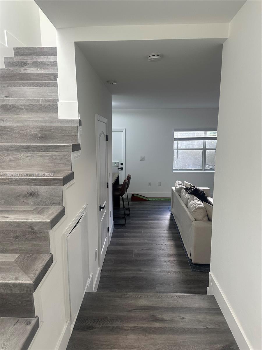 3067 Center Street, Unit 17 Miami, FL 33133 - Photo 6 of 21 a view of a hallway view with wooden floor and staircase