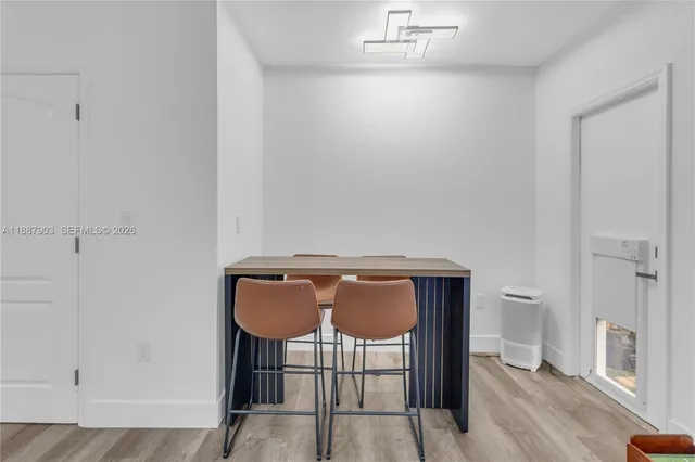 a view of a room with a table and chairs