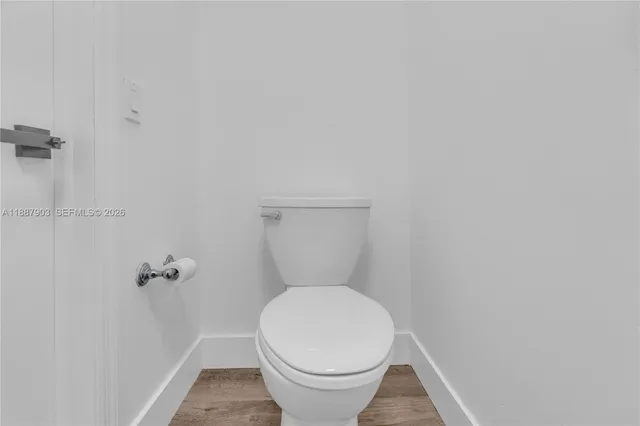 a white toilet sitting in a bathroom