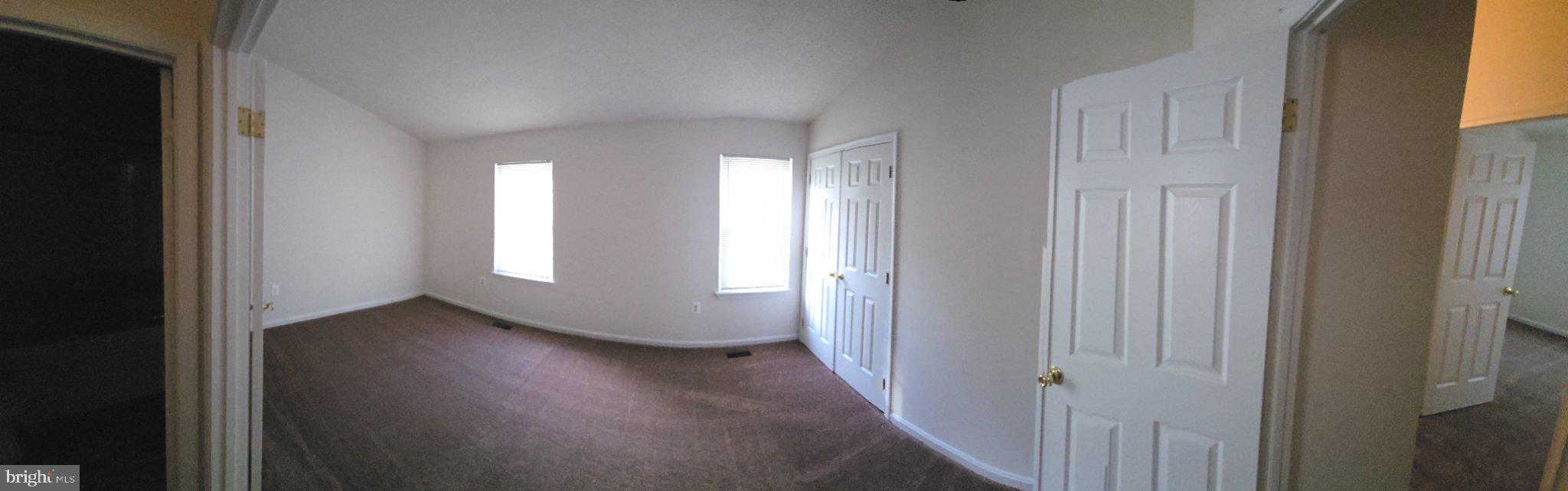 809 St Michaels Drive Bowie, MD 20721 - Photo 14 of 17 a view of an empty room with wooden floor and a window