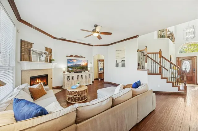 a living room with furniture and wooden floor