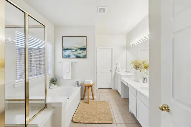 a spacious bathroom with a tub and shower
