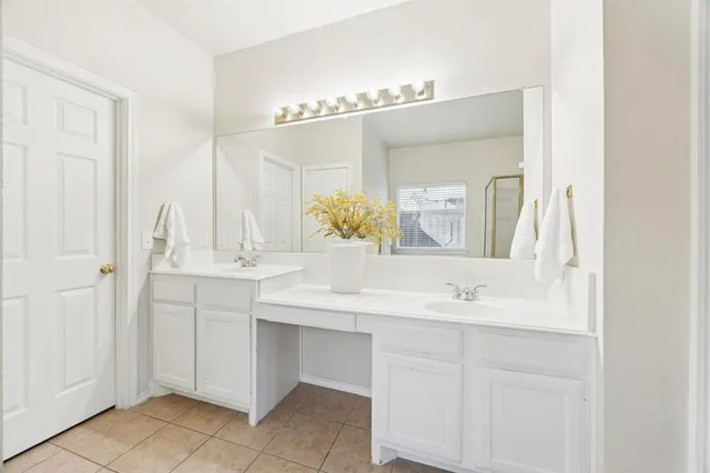 a bathroom with a sink vanity and a mirror