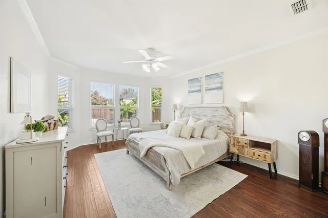 a bedroom with a bed window and a chandelier