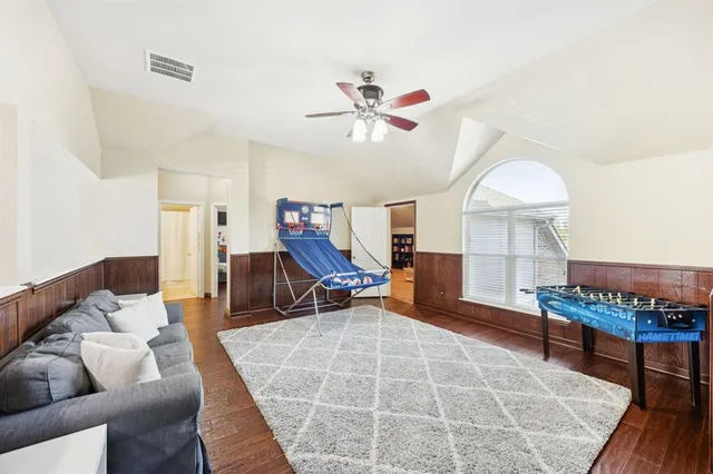 a living room with furniture a piano and a rug
