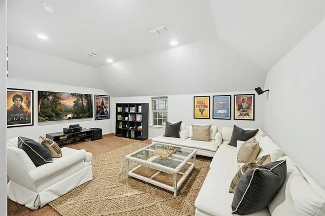a living room with furniture large window and a flat screen tv