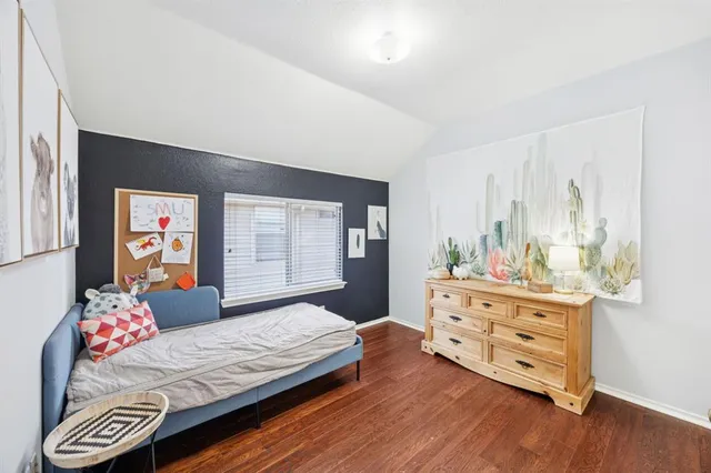 a bedroom with a bed and a dresser in it