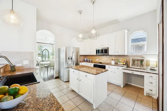 a kitchen with a sink stove and refrigerator