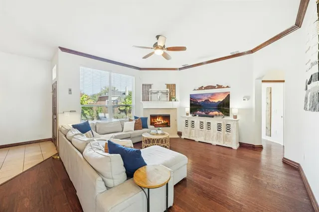 a living room with furniture fireplace and flat screen tv