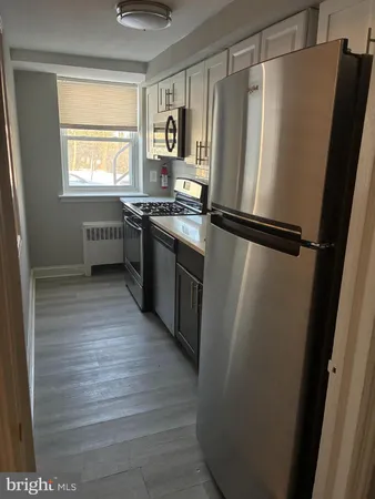 a kitchen with a refrigerator and a stove