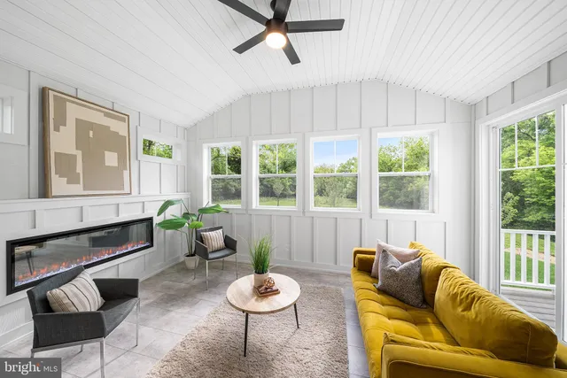 a kitchen with stainless steel appliances kitchen island granite countertop a refrigerator a stove a sink a dining table and chairs with wooden floor