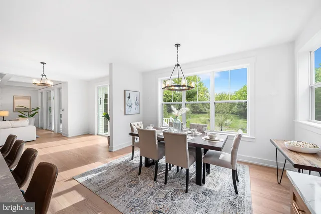 a kitchen with stainless steel appliances granite countertop a sink counter space and dining table
