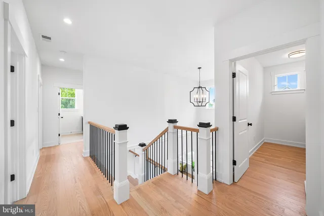 a view of a bedroom with wooden floor