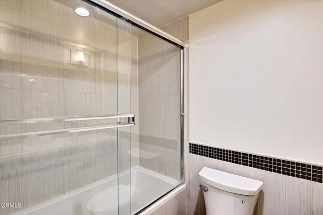a bathroom with a shower and a toilet