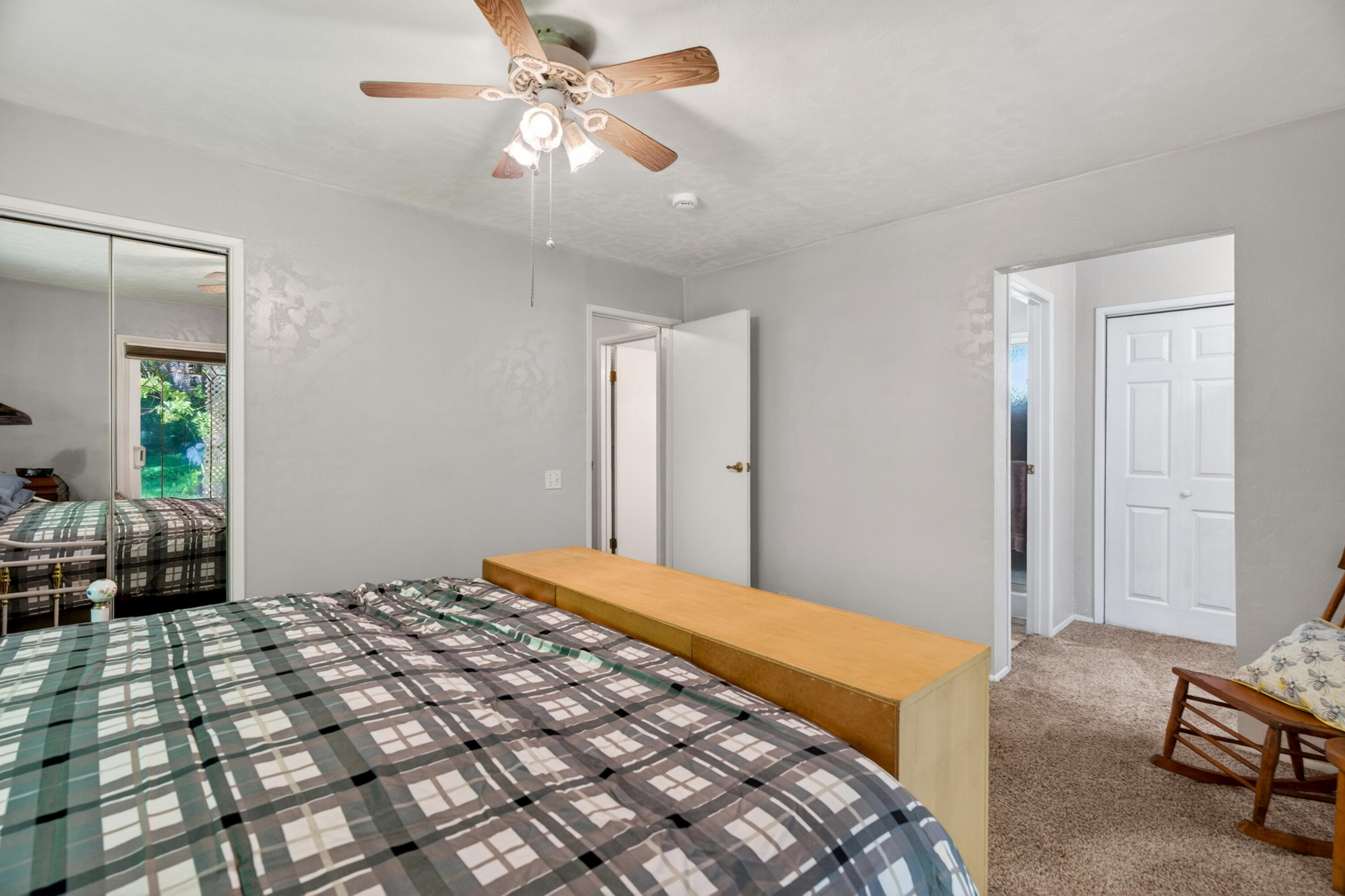 8015 Starlite Pines Road Shingletown, CA 96088 - Photo 22 of 38 a bedroom with a bed and a chandelier
