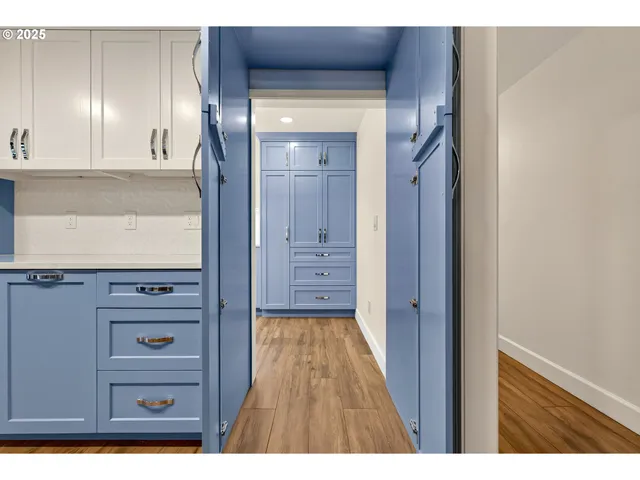 a view of a hallway with a wooden cabinet