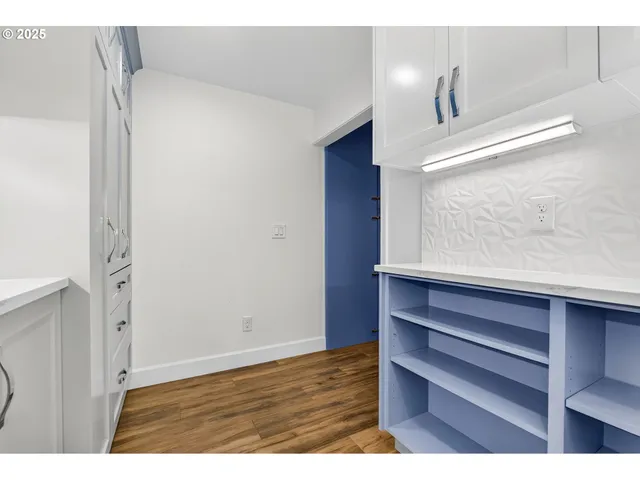 a view of wooden floor and windows in a room