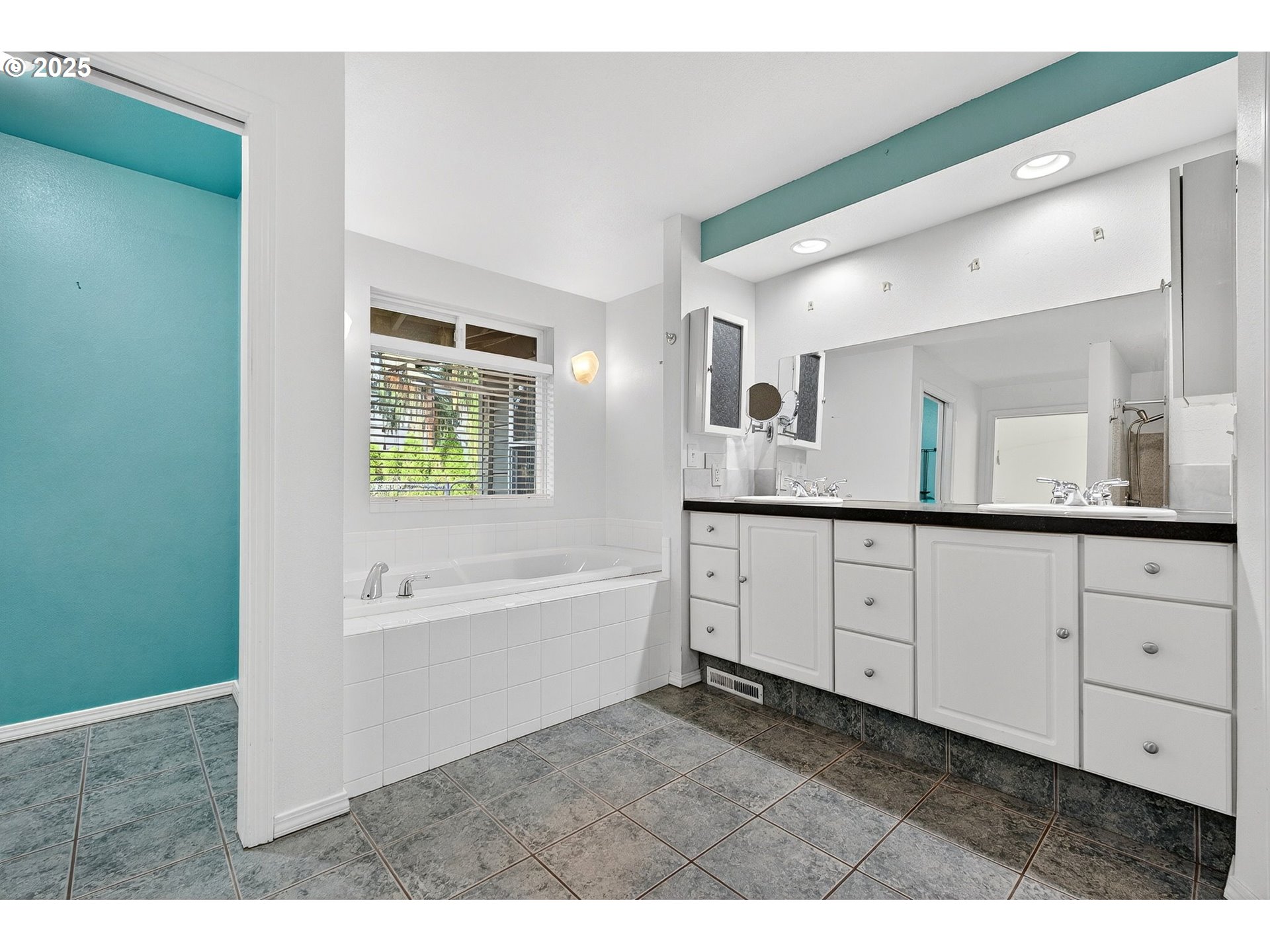 14595 Southwest 144th Avenue Portland, OR 97224 - Photo 25 of 43 a bathroom with a tub a double vanity sink and a mirror