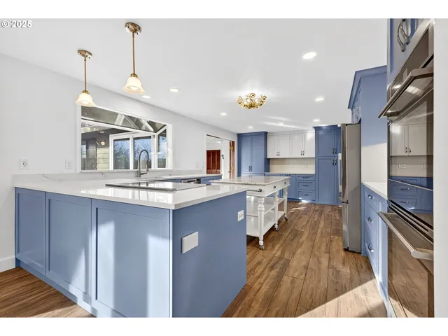 a kitchen with stainless steel appliances granite countertop a sink stove and refrigerator